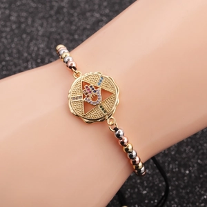 Three-tone gold bead bracelet with zircon Hamsa Hand charms on an adjustable cord