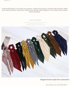 Detailed flat lay of velvet bow hair ties with long ribbons in ten varied colors
