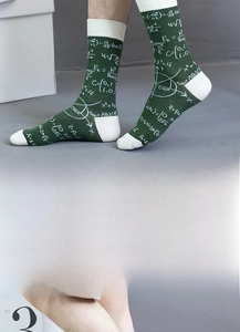 Detail of dark green cotton crew socks featuring white math formulas and geometric patterns