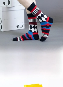 Detail of geometric pattern crew socks with multicolored diamond and wave textures