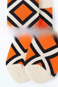 Detail view of elastic ribbed cuff and soft geometric patterns on cotton mid-calf socks