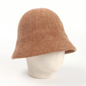 Detailed texture of brown chenille knit bucket hat on white mannequin stand