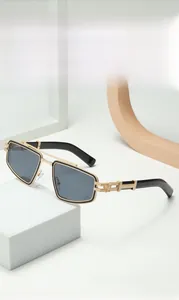 Close-up of golden geometric frames with intricate mechanical hollow temples and black lenses