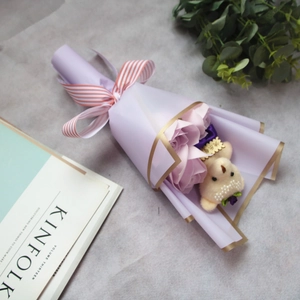 Detailed view of light purple soap rose bouquet with a cute beige teddy bear gift