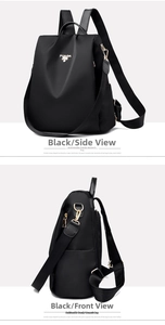 Detail view of black oxford nylon backpack featuring golden bee hardware and brand logo