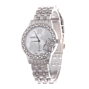 Macro side view of silver metal watch band and bezel encrusted with sparkling rhinestones
