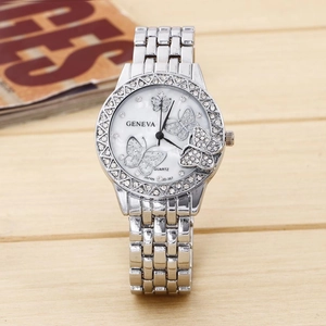 Macro shot of silver steel watch dial with diamond-studded butterfly accents