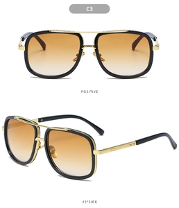 Detail view of retro aviator sunglasses with orange gradient lenses and gold metal frames