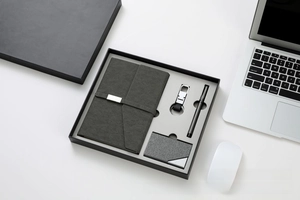 Detail of premium business gift set featuring leather notebook and metal key chain
