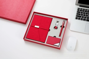 Close-up of a premium red leather business stationery gift set with a matching red gift box