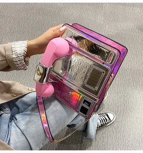 Detail of laser pink telephone bag showing metallic chain and holographic dial