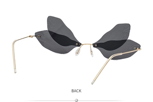 Back view of dragonfly wing sunglasses showing gold metal frame and smoke grey lenses