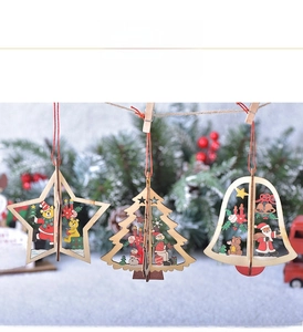 Detailed view of laser-cut wooden Christmas ornaments with star, tree and bell shapes