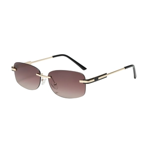 Frameless sunglasses with gradient tea lenses and elegant gold metal frames on white