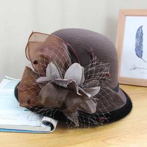 Detail of coffee brown wool felt hat with vintage floral decor and black mesh veil