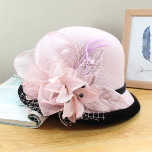 Pink wool felt cloche hat with mesh veil flower and purple feather decoration