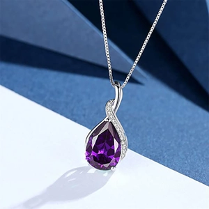 Detailed view of teardrop purple crystal pendant with sparkling silver setting