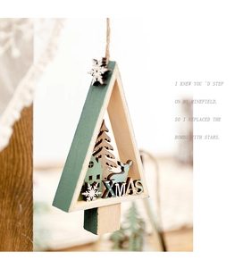 Macro detail of a wooden Xmas tree pendant featuring reindeer silhouettes and XMAS text