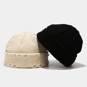Distressed knit beanies in black and beige with ripped details for street fashion