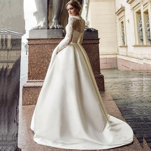Elegant ivory lace long sleeve wedding dress with heavy satin train and hidden pockets
