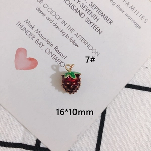 Detailed view of a 16x10mm red enamel strawberry charm with gold plating for DIY jewelry