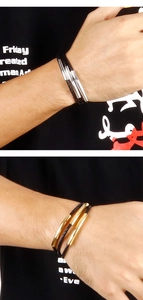 Detail of men's multi-layer braided leather bracelet with gold and silver metal tubes
