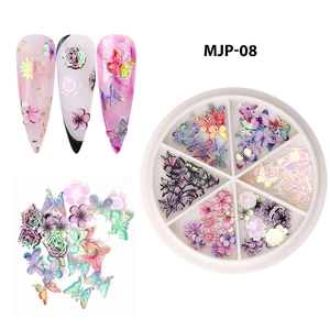 Detail of Christmas nail art wood pulp flakes with butterfly and floral charms in a 12-grid set