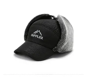 Detail view of winter trapper hat showing crackle texture fabric and gray faux fur lining