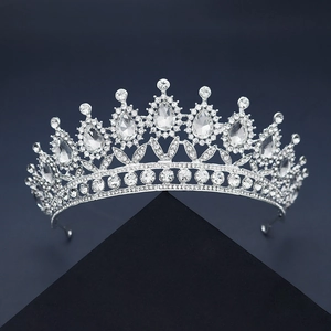 Exquisite silver tiara with sparkling crystal rhinestones on a premium display stand