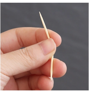 Close-up of a double-pointed bamboo toothpick showing natural wood fiber and texture
