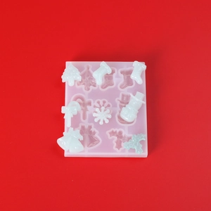 Detailed view of Christmas silicone mold and white DIY resin crafts on red background
