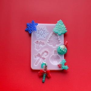 Detailed Christmas silicone mold featuring snowflake, tree, and candy cane resin shapes