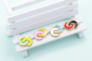 Close-up of interlocking C earrings with colorful enamel and sparkling crystal pavé