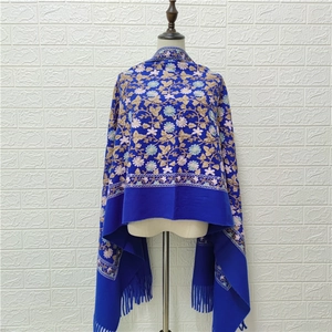 Blue cashmere-feel shawl featuring floral embroidery and elegant tassel trim details