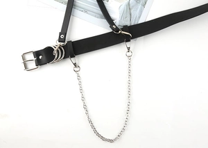 Detail of punk style black belt with silver metal rings and detachable chain accessories