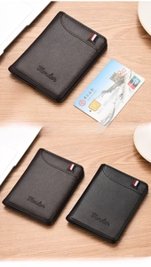 Close-up of slim men's leather wallet featuring lychee texture and tricolor ribbon detail