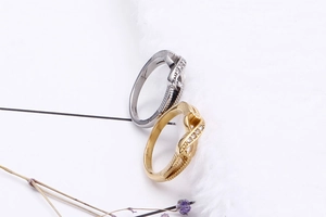Detailed view of intertwined gold and silver steel rings with sparkling cubic zirconia