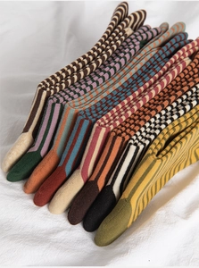 Close-up of assorted ribbed cotton socks in vintage stripes and solid autumn earth tones