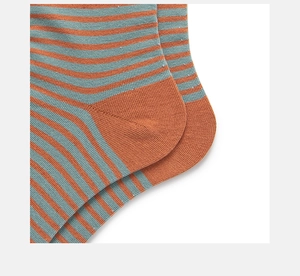 Detailed close-up of orange and blue striped cotton socks showing heel knitting texture
