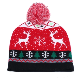 Knitted Christmas hat with festive reindeer and snowflake patterns and a soft pom-pom