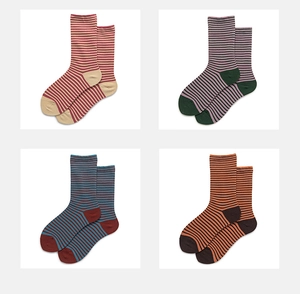 Detail view of four-color cotton crew socks with classic striped patterns and contrast heels