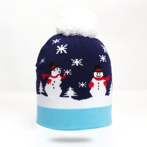 Close-up of knit winter beanie featuring festive white snowman and snowflake patterns