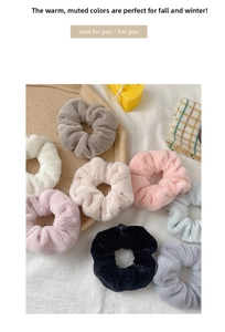 Set of 8 plush faux fur scrunchies in soft autumn colors displayed on a white tray