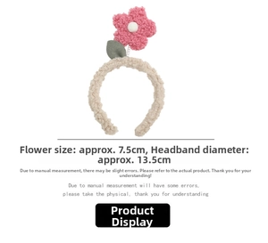 Detail of plush lamb wool headband with a 7.5cm pink flower and green leaf detail