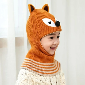 Detailed view of child wearing an orange fox knit hat with integrated warm neck scarf