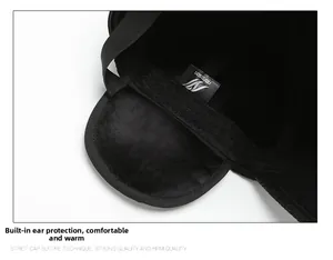 Detail of warm black baseball cap with fleece lining and foldable ear flaps for winter