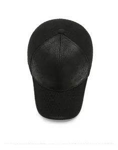 Detailed top view of black baseball cap with leather texture and diamond grid fabric