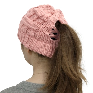 Pink chunky knit ponytail beanie featuring a back opening for high hair styles