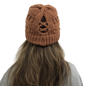 Women's knit ponytail beanie featuring a criss-cross back opening in caramel brown