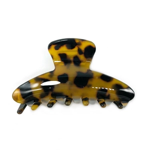 Minimalist leopard print acetate hair claw clip with tortoise shell pattern on white background